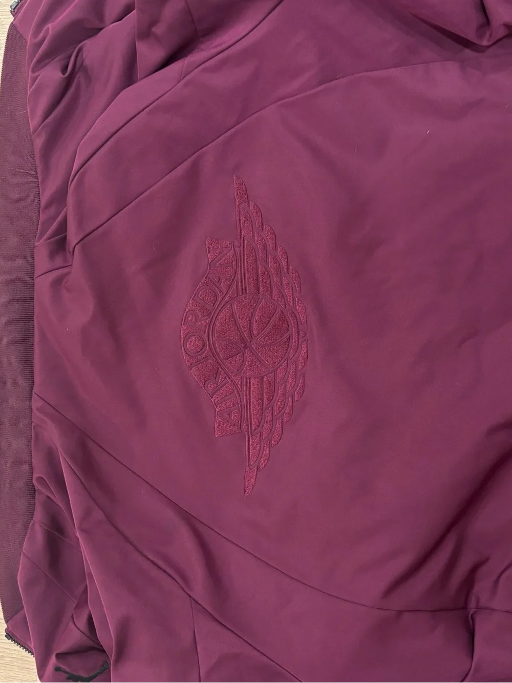 Classic Jordan Sportswear Wings MA-1 jacket features a burgundy wine colorway